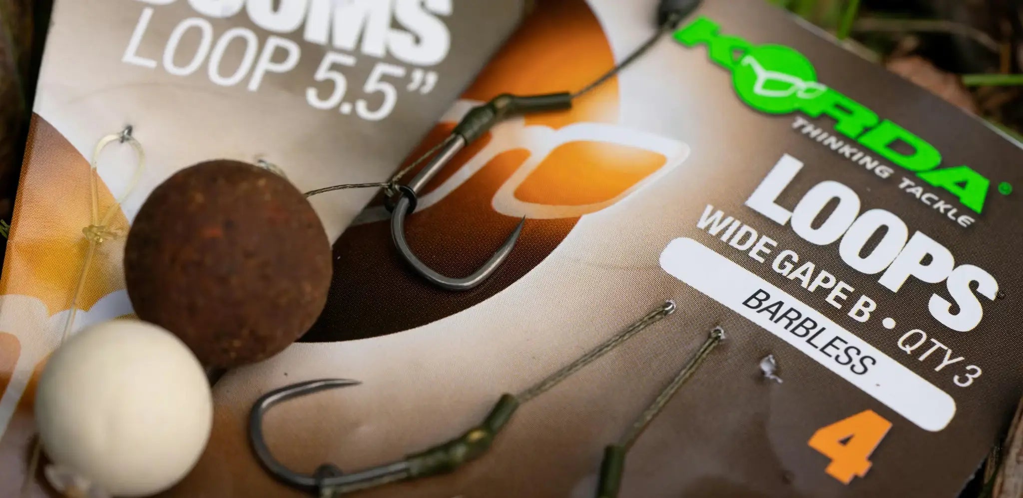 Black barbless Korda loops hooks with bait pellets for combi rig