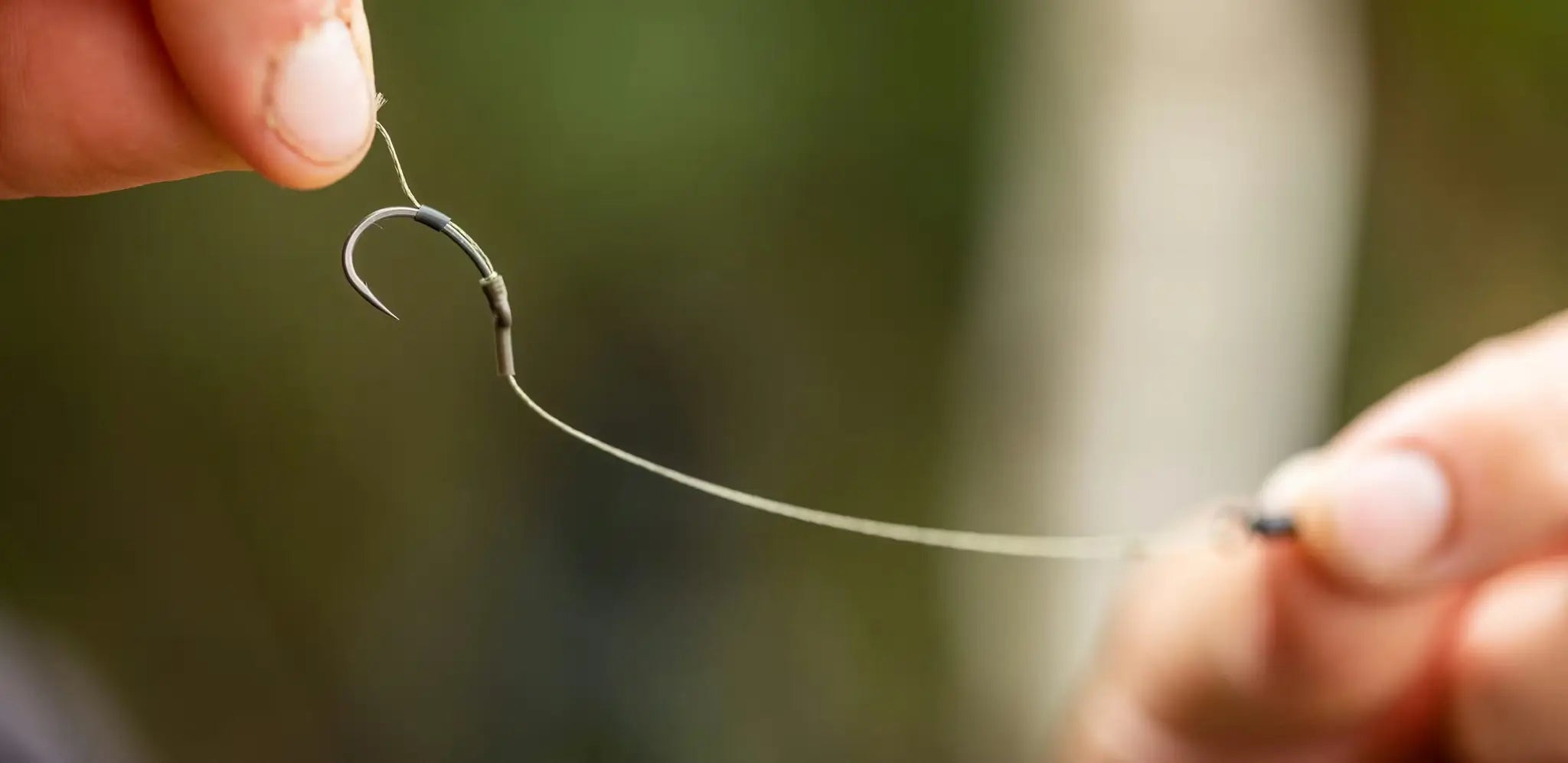 Black curved fishing hook for solid bag rig tying