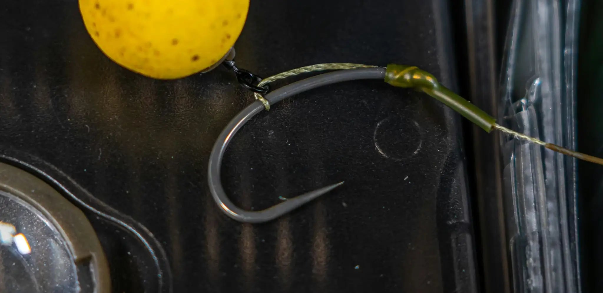 Dark gray curved Slip D rig hook with sharp point and green swivel