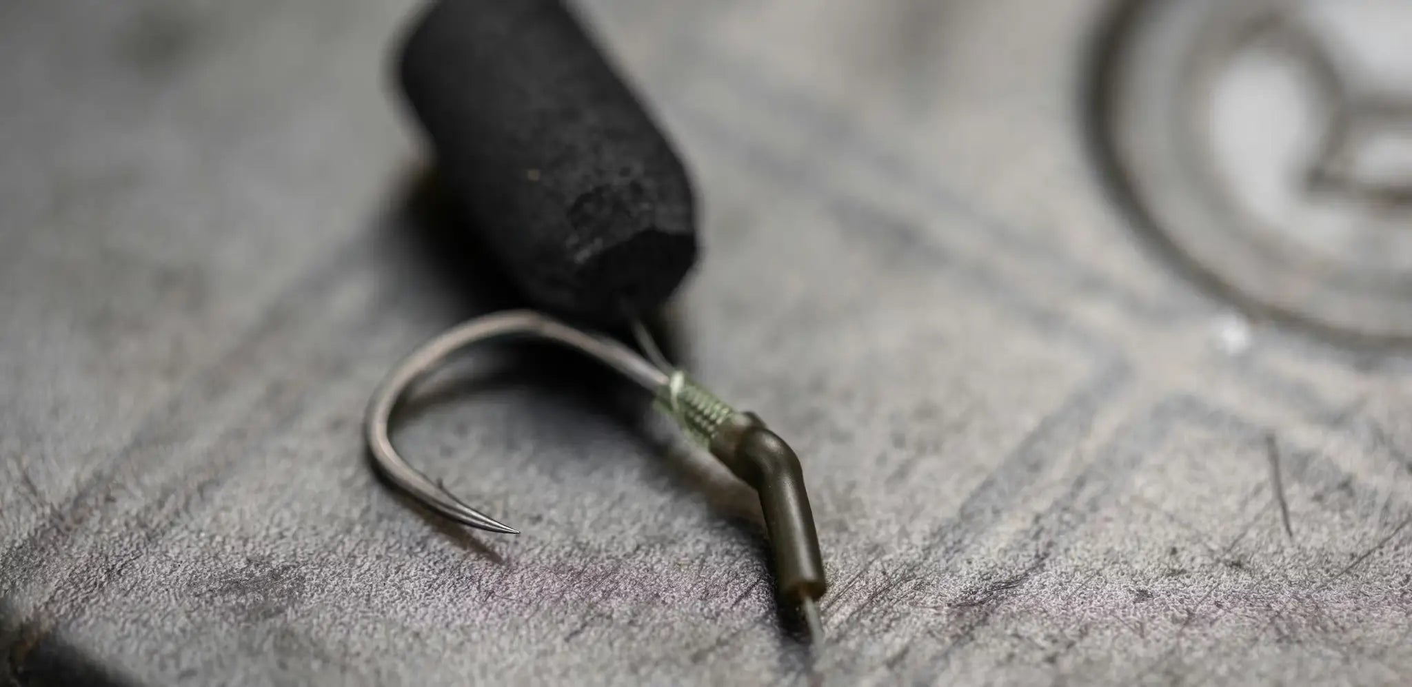 Black cylindrical zig rig sinker with hook and wire connector