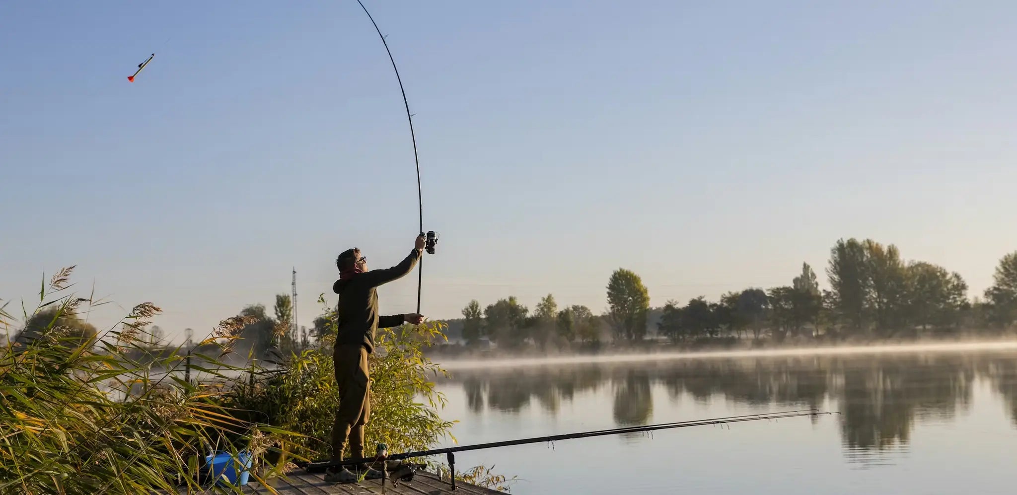 Person using marker float rod on wooden dock in how-to guide