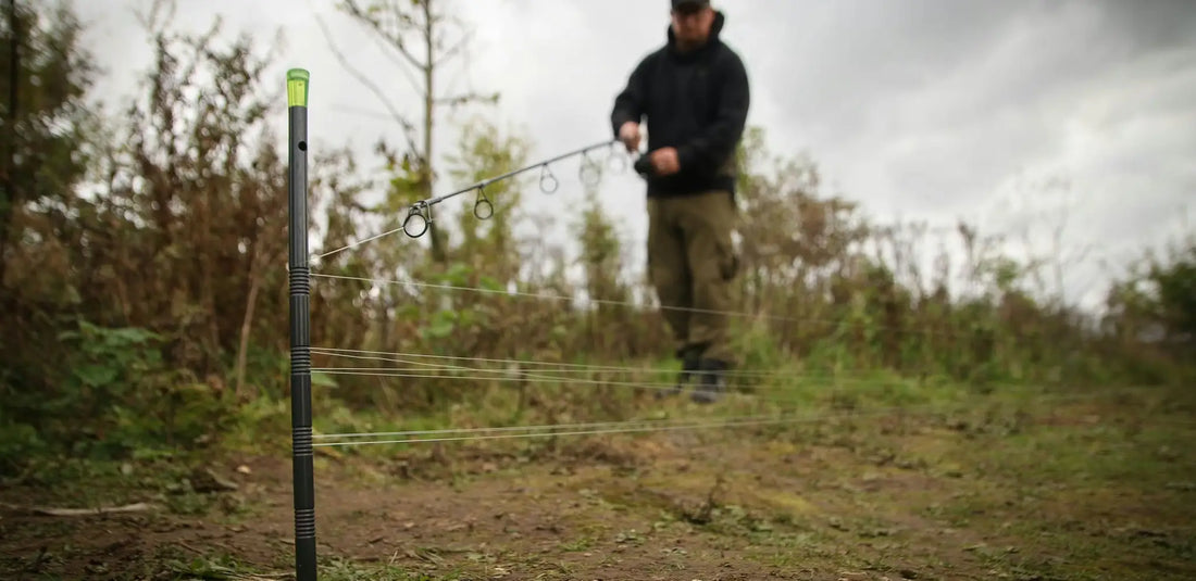 Black fishing rod with green tip and silver rings for distance sticks