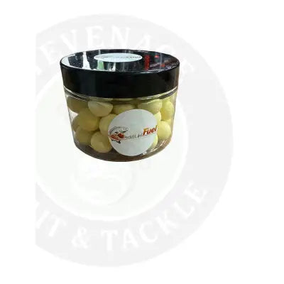 Clear plastic jar with black lid containing yellow carp fuel pop ups fishing boilies labeled carp fuel