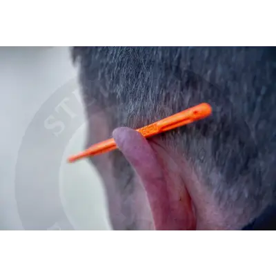 Orange plastic disgorger medium earplug with textured grip and embossed branding for durable fishing tackle use