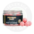 Pink speckled 15mm fluorescent fishing bait balls in a clear jar labeled dynamite baits fluro pop-downz