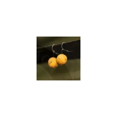 Two golden-yellow 12mm dynamite baits peppered fruit boilies hanging from black wire hooks for fishing bait