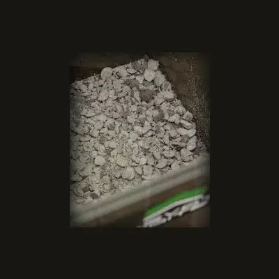 Gray chunky gravel in a container for elevate baits garlic infusion crush natural garlic infusion crush bait material