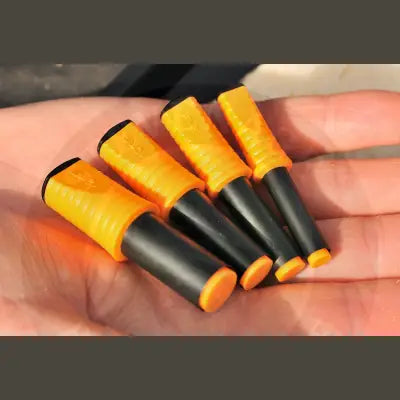 A hand holding four bright yellow and black fire starters with textured grips alongside gardner tackle gpb polarised sunglasses