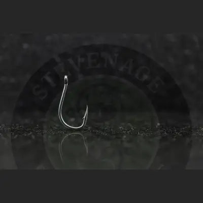 Shiny silver fishing hook with sharp point and curved shape for stevenage bait using tungsten-impregnated rubber weights