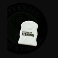 White plastic toothpick holder with live for fishing text featuring premium bait floss designed for fishing use