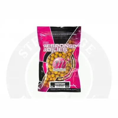 A vibrant pink and black mainline carp response pineapple and banana 15mm handy pack showing golden sweetcorn bait pellets