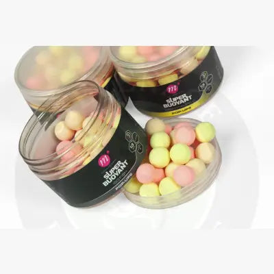 Pink and yellow super buoyant pop-ups 13mm in clear jars with black mainline carp labels for carp fishing bait