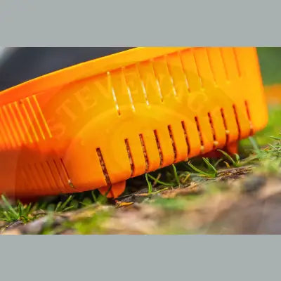 Bright orange plastic guru bait strainer with vertical slits and small feet for efficient pint bait strainer use