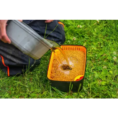 Orange and black plastic guru bait strainer with yellow handle five pint capacity for stevenage bait mixing