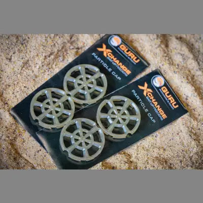 Four translucent grey plastic guru x-change bait feeders with radial spoke design for loose particles and stevenage bait