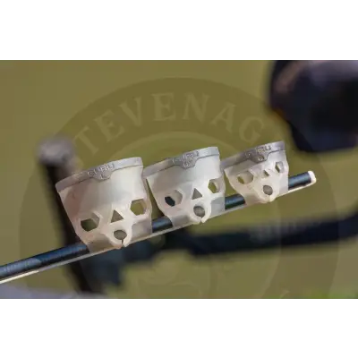 Three white skull-shaped grip covers with guru branding on dark bow limb for tackle guru-fast release pole pots small x 2