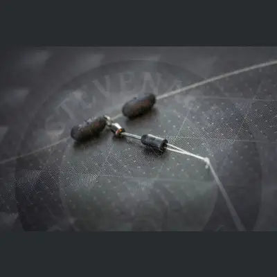 Black cylindrical fishing sinkers connected by metal wire for guru heli swivel stevenage bait purpose designed quick change