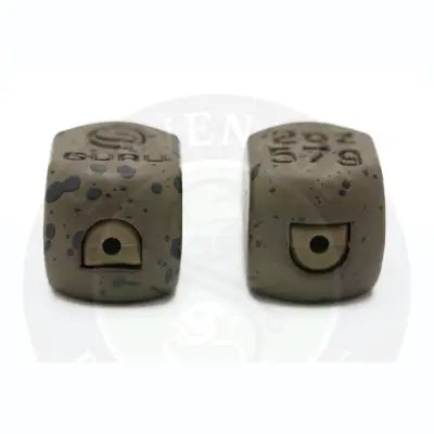 Two matte speckled gray concrete inline x-safe lead cubes with engraved branding and central circular cutouts for ultimate safe bagging