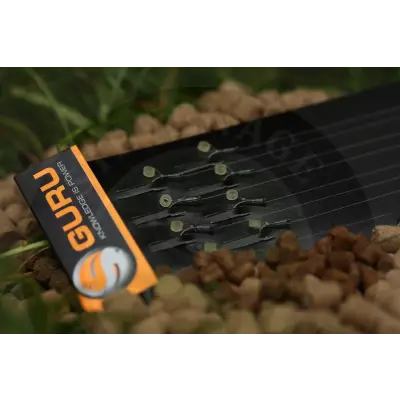 Black guru lwg bait band rig fishing hooks with translucent greenish beads arranged neatly on a black tray