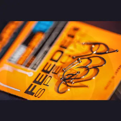 Black fishing hooks with shiny metallic finish on orange lwg feeder package featuring original spade-end pattern