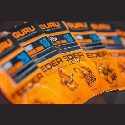Orange and black packaged guru lwg feeder hooks with original spade-end pattern and metallic silver micro barb design