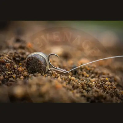 Silver-toned lwg feeder fishing hook with round stevenage bait pellet and original spade-end pattern eye