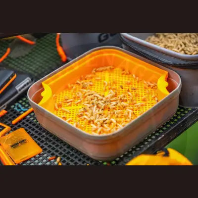 Orange plastic bait tray filled with worms for guru maggot riddle by tackle guru stevenage bait use