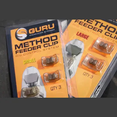 Tackle Guru method clip small size packaged in clear plastic with orange black labeling for guru method feeder frame