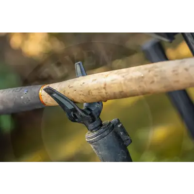 Black plastic mini stealth reaper rear rest gripping light brown cork-handled fishing rod with orange band