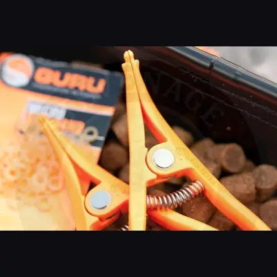 Bright orange plastic pellet pliers with silver spring and metallic pivot points for stevenage bait and bait band use