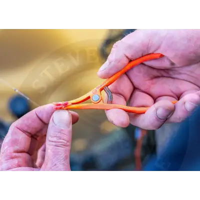 Orange plastic-handled bugu pellet pliers with silver spring and metal pivot point used for stevenage bait band tasks