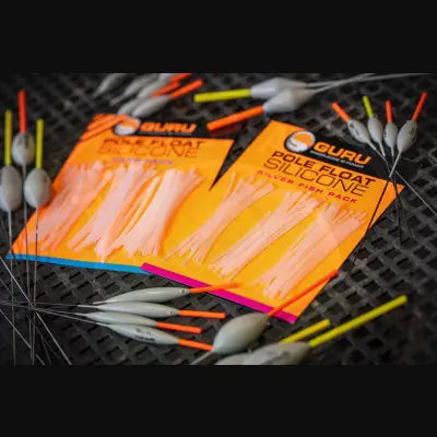 Orange-packaged tackle guru guru pole float silicone carp packs with translucent pink and silver silicone floats from stevenage bait