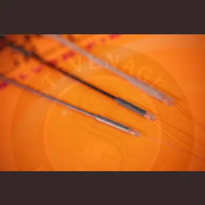 Three slender metallic cables with transparent casings and black connectors for tackle guru pole float silicone carp