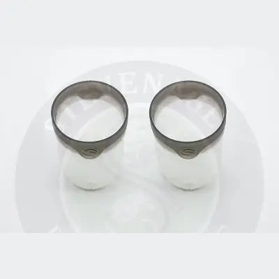 Two translucent white cylindrical pole pots with dark gray rims and small logos from tackle guru for stevenage bait use