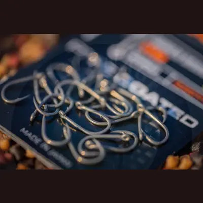 A pack of shiny metallic tackle guru smwg barbed fishing hooks with curved design and sharp points for stevenage bait use