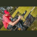 A golden-yellow fish held by a person in red gear showcasing the tackle guru triple pack keepnet promo in stevenage bait