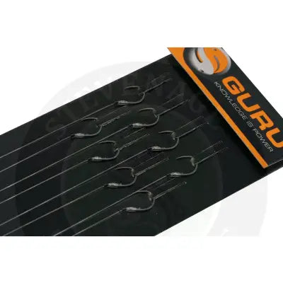 Black guru extra wide gape fishing hooks for carp pole rigs neatly arranged on a black stevenage bait tray