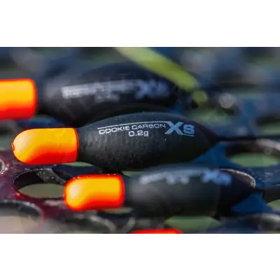 Tackle guru xs cookie carbon fishing float with a sleek black and orange carbon fiber body for modern commercial anglers